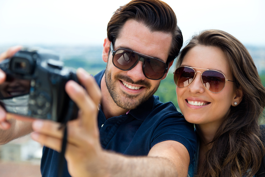 Young tourist couple taking photo of themselves.